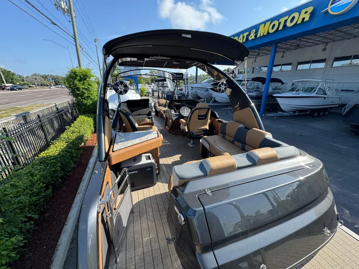  Yacht Photos Pics 2025 Avalon Excalibur 27' luxury boat at dealership, showcasing sleek design and spacious interior.