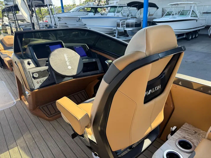  Yacht Photos Pics 2025 Avalon Excalibur 27' boat interior with modern helm and tan seating.