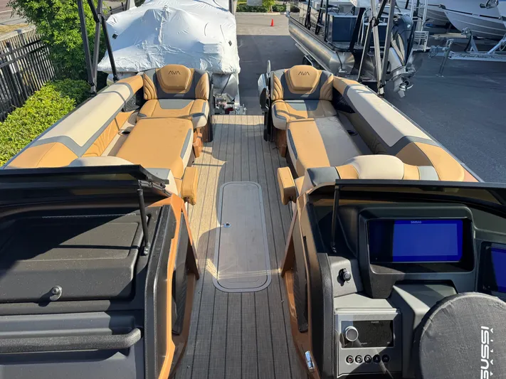  Yacht Photos Pics 2025 Avalon Excalibur 27' boat interior with luxurious seating and modern dashboard.