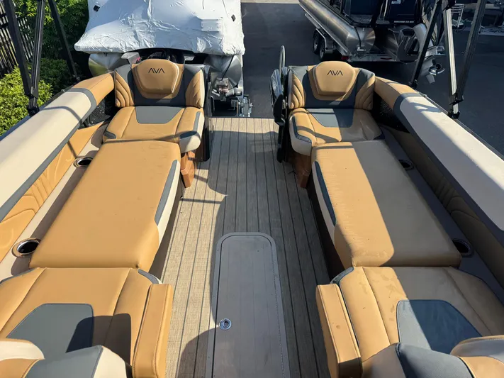  Yacht Photos Pics Luxurious 2025 Avalon Excalibur 27' boat interior with tan seating and wood flooring.