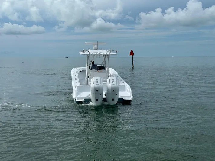  Yacht Photos Pics 2025 Yellowfin 32 boat on open water under cloudy sky.