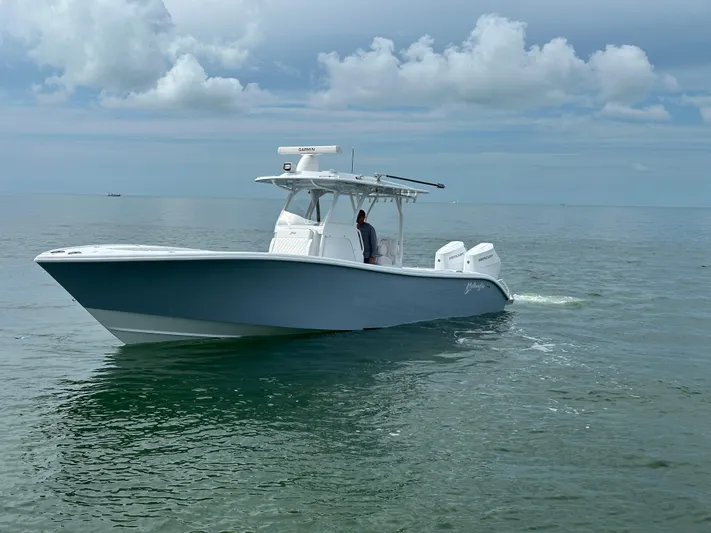  Yacht Photos Pics 2025 Yellowfin 32 boat cruising on calm ocean waters under cloudy sky.