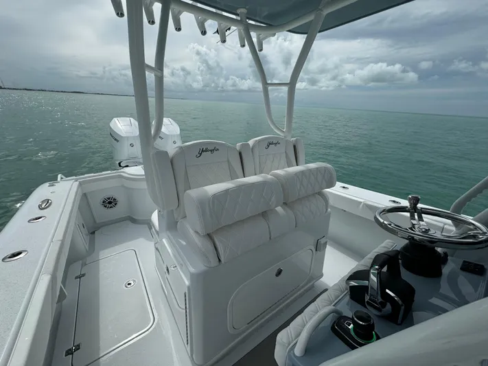  Yacht Photos Pics 2025 Yellowfin 32 boat interior with helm, seating, and ocean view.