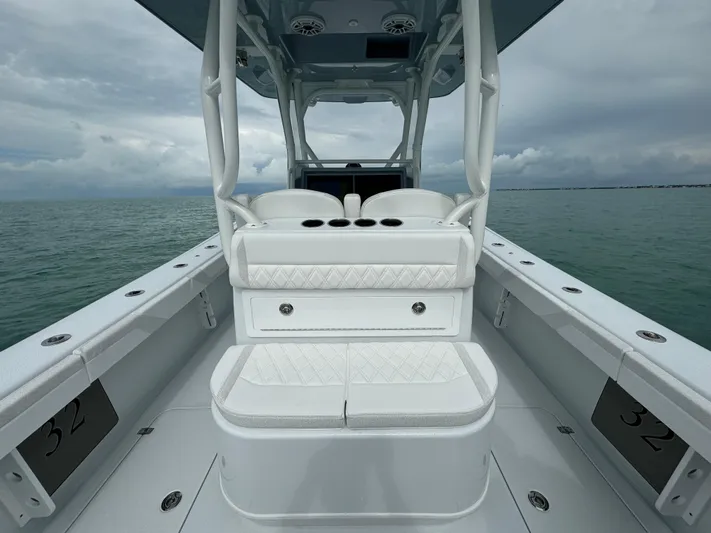  Yacht Photos Pics 2025 Yellowfin 32 boat interior with white seating on calm water.