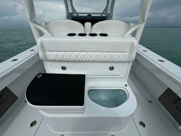  Yacht Photos Pics 2025 Yellowfin 32 boat interior with seating and storage on open water.