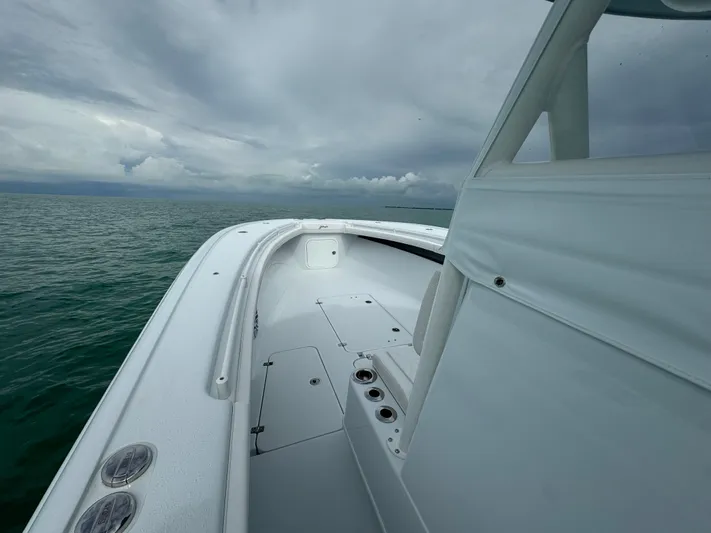  Yacht Photos Pics 2025 Yellowfin 32 boat on open water under cloudy skies.