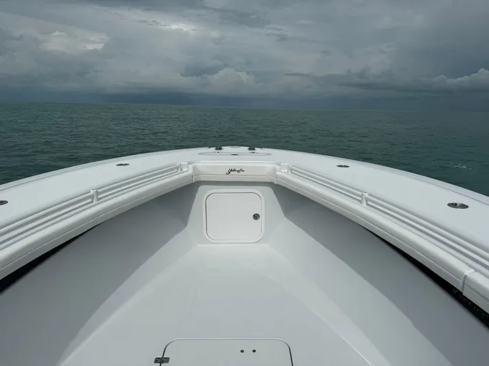  Yacht Photos Pics Bow view of 2025 Yellowfin 32 boat on open sea under cloudy sky.