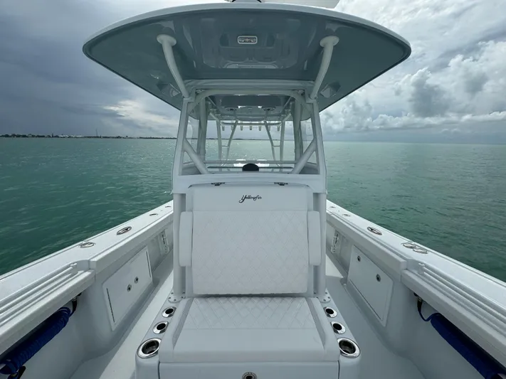  Yacht Photos Pics 2025 Yellowfin 32 boat on calm sea under cloudy sky.