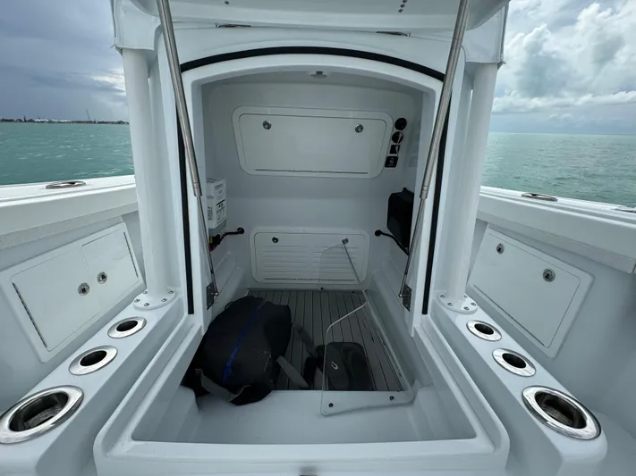  Yacht Photos Pics 2025 Yellowfin 32 boat interior with storage compartments and rod holders.