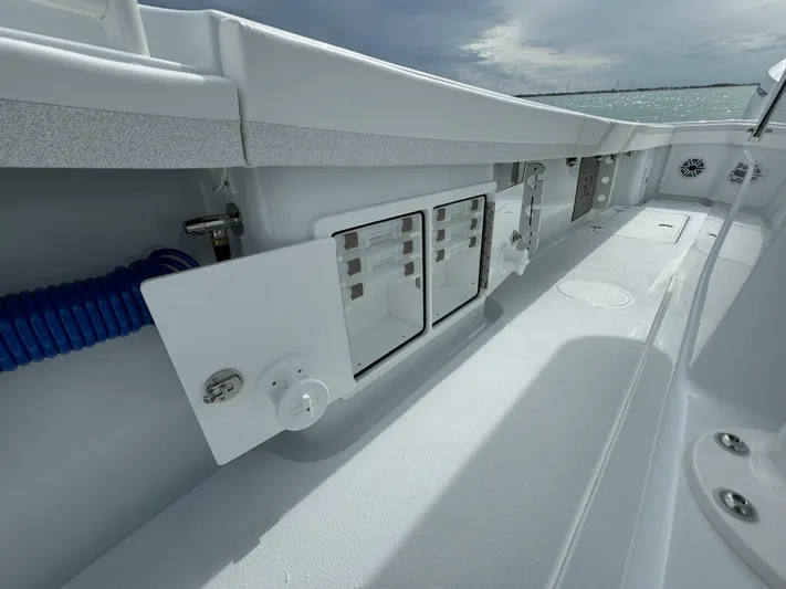  Yacht Photos Pics 2025 Yellowfin 32 boat interior with storage compartments and sleek design.