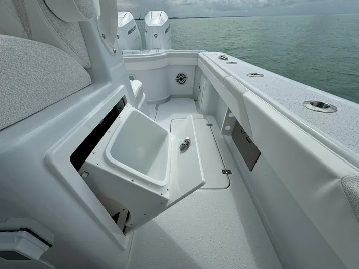  Yacht Photos Pics 2025 Yellowfin 32 boat interior with open storage compartment, ocean view.