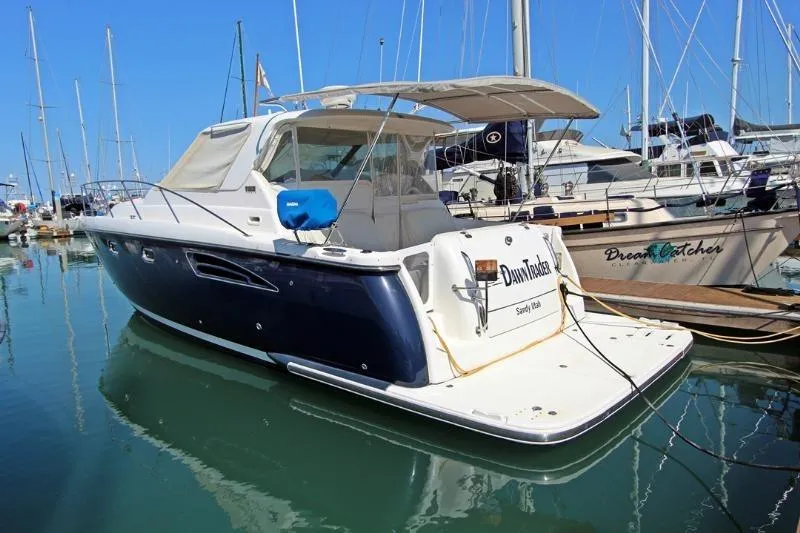  Yacht Photos Pics 2005 Tiara Yachts 3600 Sovran docked in a marina, surrounded by sailboats.