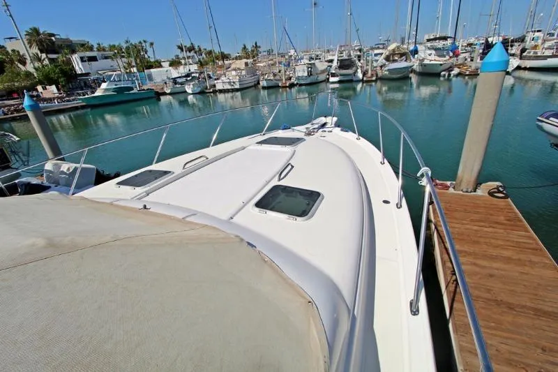  Yacht Photos Pics 2005 Tiara Yachts 3600 Sovran docked in a marina, surrounded by boats.