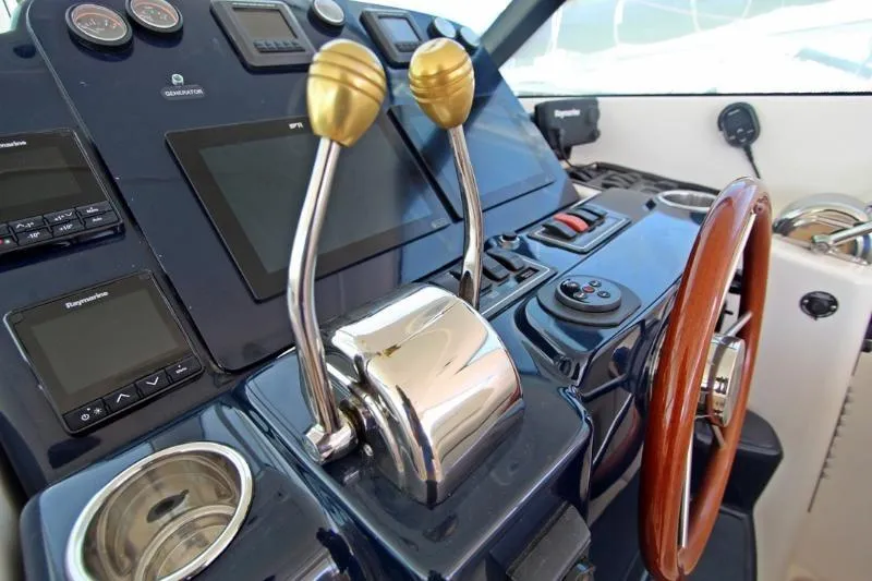  Yacht Photos Pics Control panel of a 2005 Tiara Yachts 3600 Sovran with steering wheel and throttle levers.