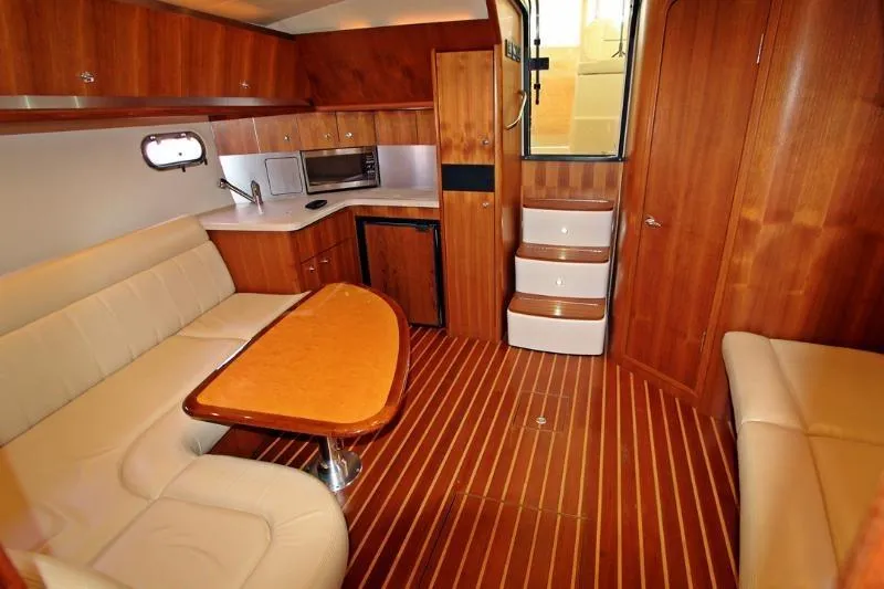  Yacht Photos Pics Luxurious interior of 2005 Tiara Yachts 3600 Sovran with wood finish and cozy seating.