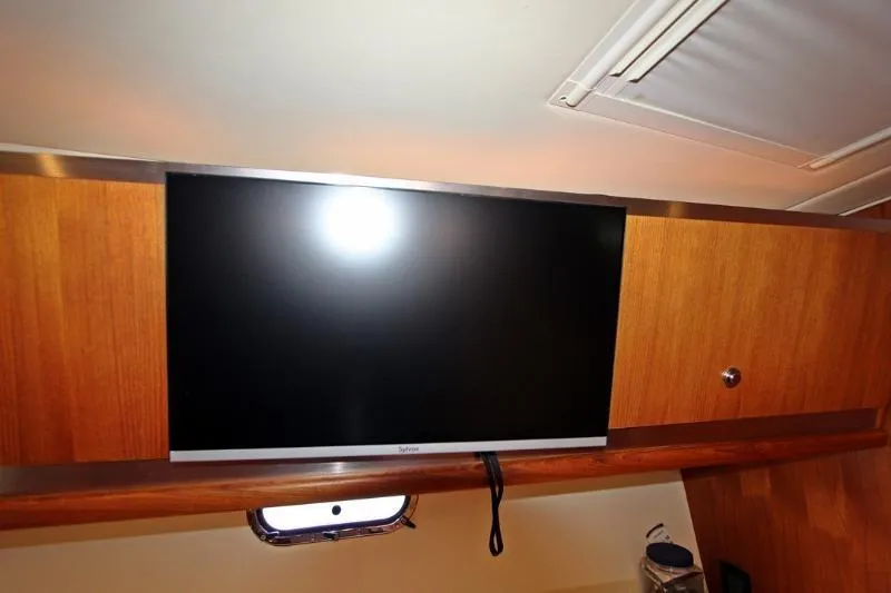  Yacht Photos Pics Flat-screen TV in 2005 Tiara Yachts 3600 Sovran interior, mounted on wooden panel.