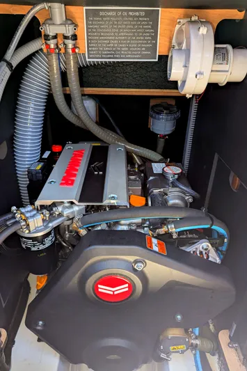 Windwaker Yacht Photos Pics Engine compartment of a 2013 Jeanneau 41 Deck Salon sailboat, showcasing mechanical components.
