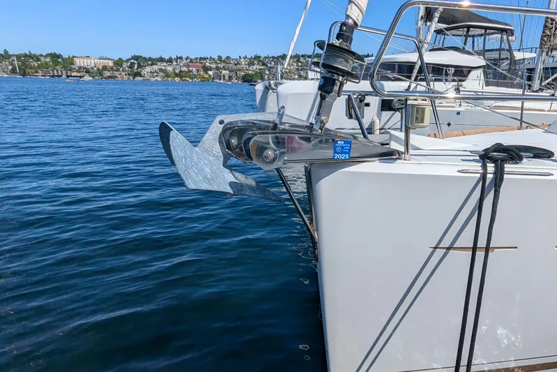 Windwaker Yacht Photos Pics 2013 Jeanneau 41 Deck Salon yacht anchored in a marina, showcasing its anchor and bow.