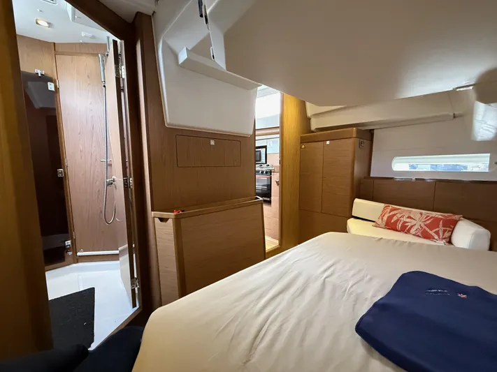 Windwaker Yacht Photos Pics Interior of 2013 Jeanneau 41 DS yacht, featuring a cozy bedroom and modern bathroom.