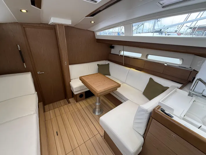 Windwaker Yacht Photos Pics Interior of 2013 Jeanneau 41 DS sailboat with wood finish and white seating.