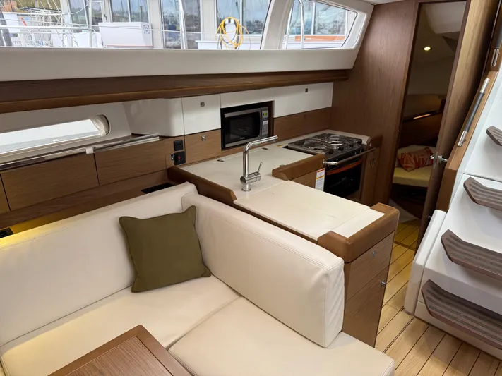Windwaker Yacht Photos Pics Interior of 2013 Jeanneau 41 DS yacht with modern kitchen and cozy seating area.