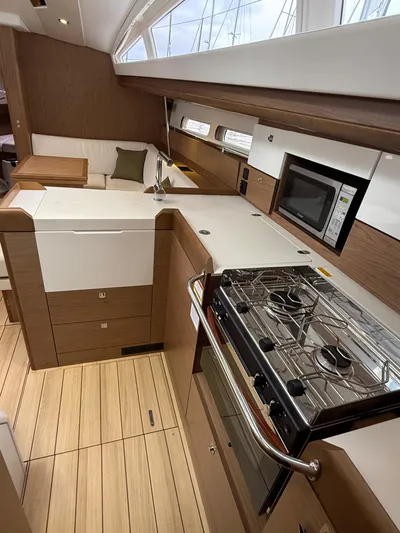 Windwaker Yacht Photos Pics Modern kitchen interior of 2013 Jeanneau 41 DS sailboat with stove and microwave.
