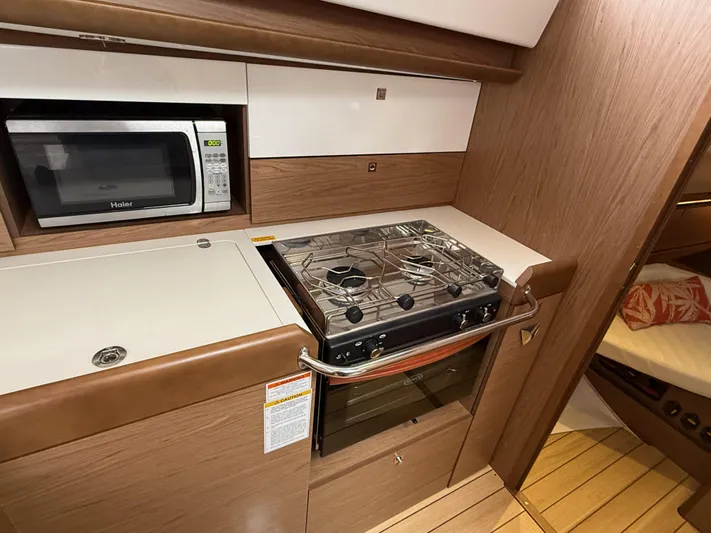 Windwaker Yacht Photos Pics Jeanneau 41 DS 2013 yacht kitchen with stove, oven, and microwave.