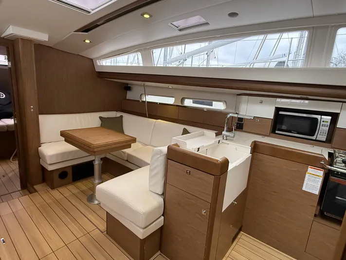 Windwaker Yacht Photos Pics Interior of 2013 Jeanneau 41 DS yacht with modern kitchen and dining area.