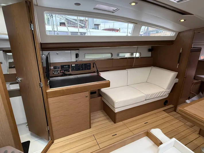 Windwaker Yacht Photos Pics Interior of 2013 Jeanneau 41 DS yacht with wood finish and white seating.