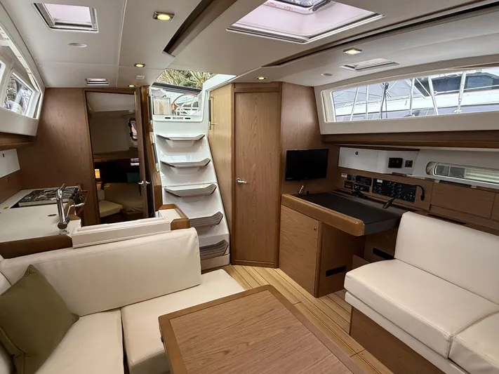 Windwaker Yacht Photos Pics Interior of 2013 Jeanneau 41 DS yacht, featuring modern wood finish and white seating.