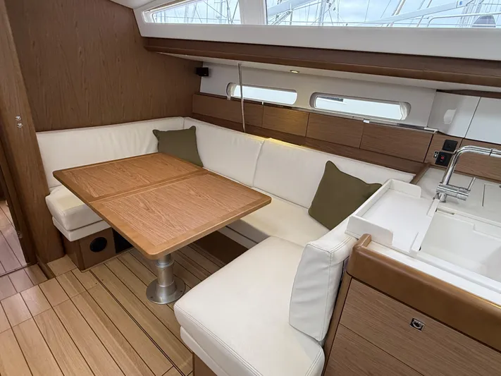 Windwaker Yacht Photos Pics Interior of 2013 Jeanneau 41 DS yacht with elegant wood and white seating.