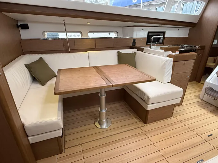 Windwaker Yacht Photos Pics Interior of 2013 Jeanneau 41 DS yacht with elegant seating and wooden flooring.