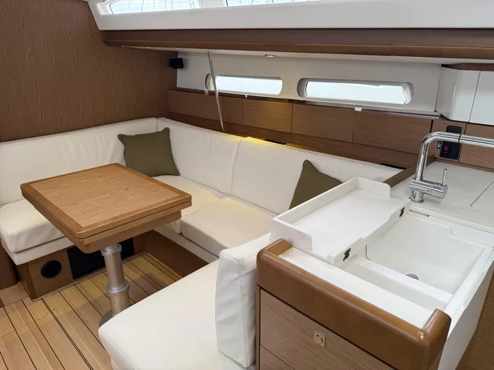 Windwaker Yacht Photos Pics Luxurious interior of 2013 Jeanneau 41 DS sailboat with modern kitchen and seating area.