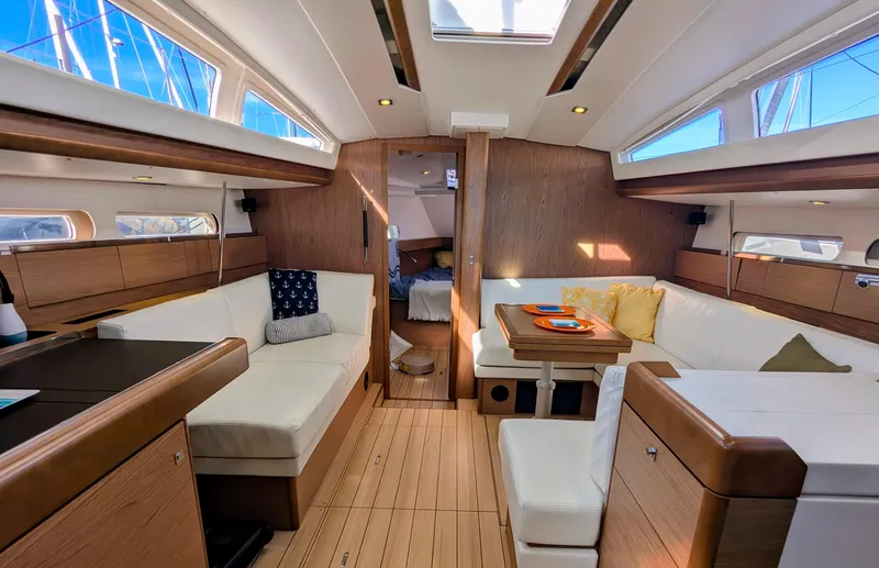 Windwaker Yacht Photos Pics Interior of 2013 Jeanneau 41 DS sailboat with modern wood finish and comfortable seating.