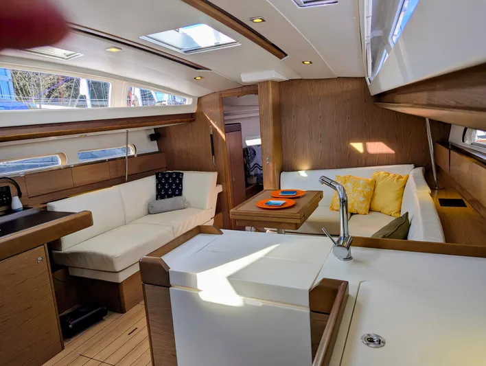 Windwaker Yacht Photos Pics Interior of 2013 Jeanneau 41 DS sailboat with modern seating and dining area.