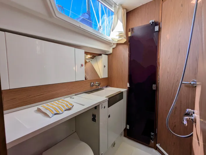 Windwaker Yacht Photos Pics 2013 Jeanneau 41 DS yacht bathroom with modern fixtures and wood accents.