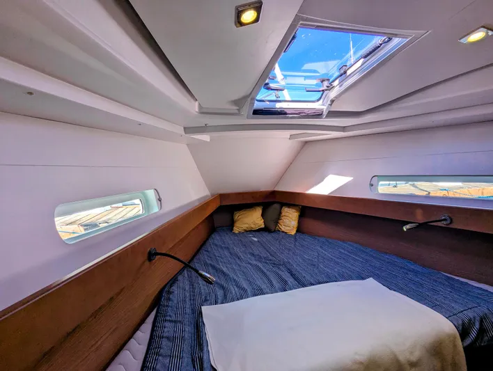Windwaker Yacht Photos Pics Cozy cabin interior of 2013 Jeanneau 41 DS sailboat with skylight and bedding.