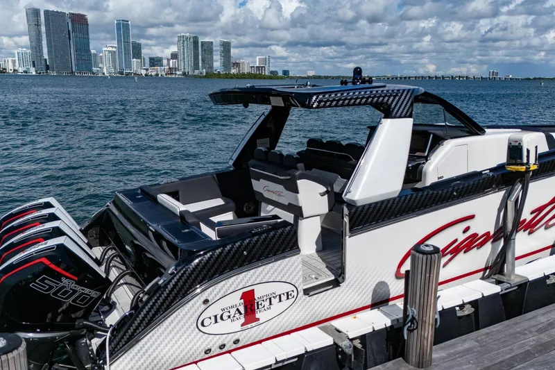  Yacht Photos Pics 2024 Cigarette 42 Auroris boat docked with city skyline in background.