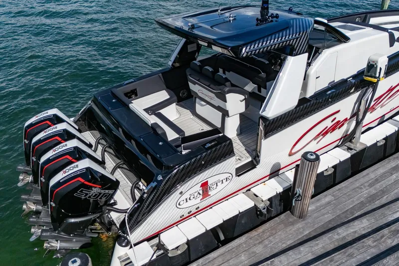  Yacht Photos Pics 2024 Cigarette 42 Auroris boat docked, featuring powerful outboard engines and sleek design.