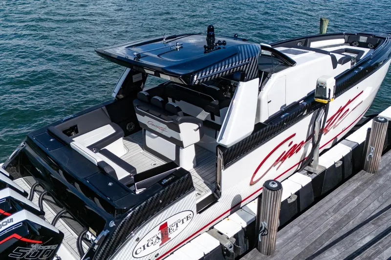  Yacht Photos Pics 2024 Cigarette 42 Auroris luxury boat docked on water, showcasing sleek design and modern features.