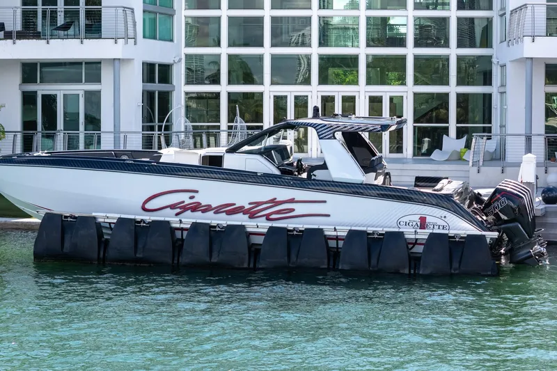  Yacht Photos Pics 2024 Cigarette 42 Auroris boat docked by modern waterfront building.