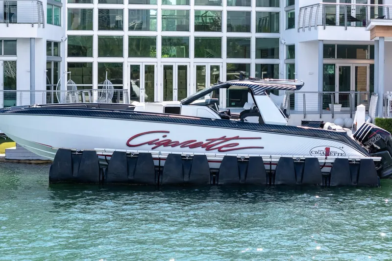  Yacht Photos Pics 2024 Cigarette 42 Auroris boat docked by modern waterfront building.