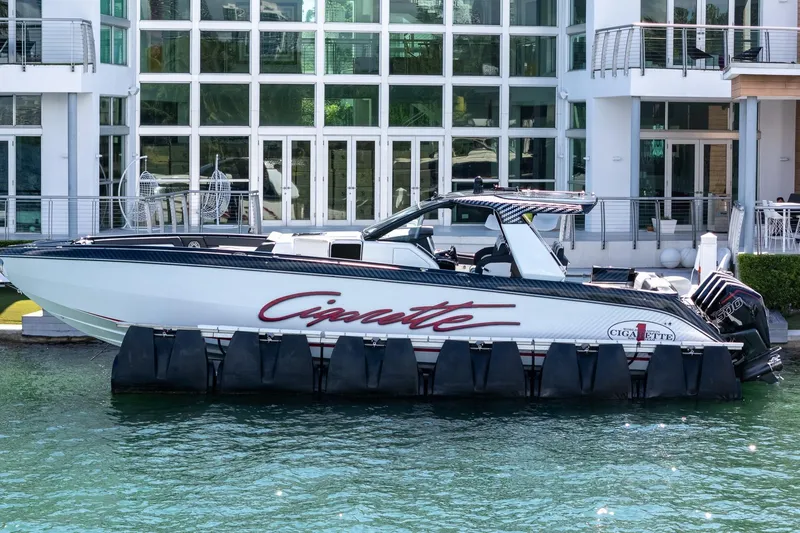  Yacht Photos Pics 2024 Cigarette 42 Auroris boat docked by modern waterfront building.