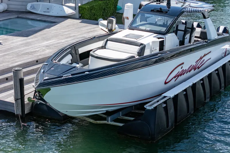  Yacht Photos Pics 2024 Cigarette 42 Auroris luxury boat docked by a wooden pier.