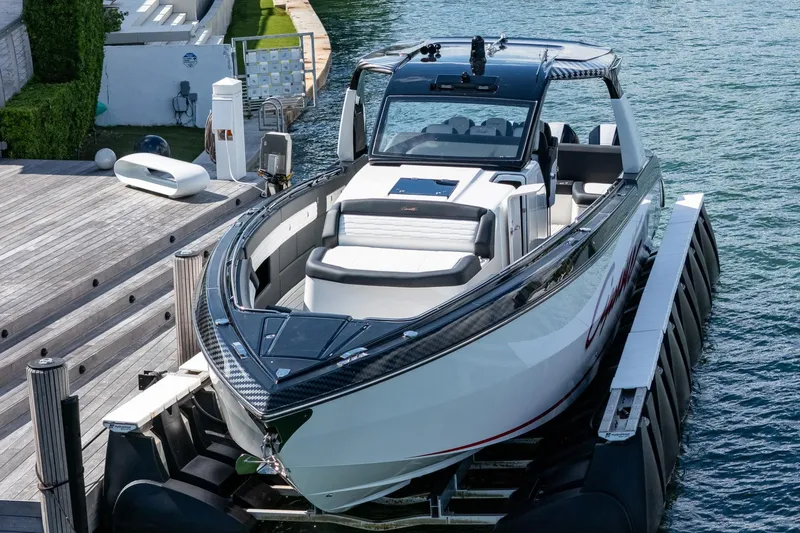  Yacht Photos Pics 2024 Cigarette 42 Auroris luxury boat docked on calm water.