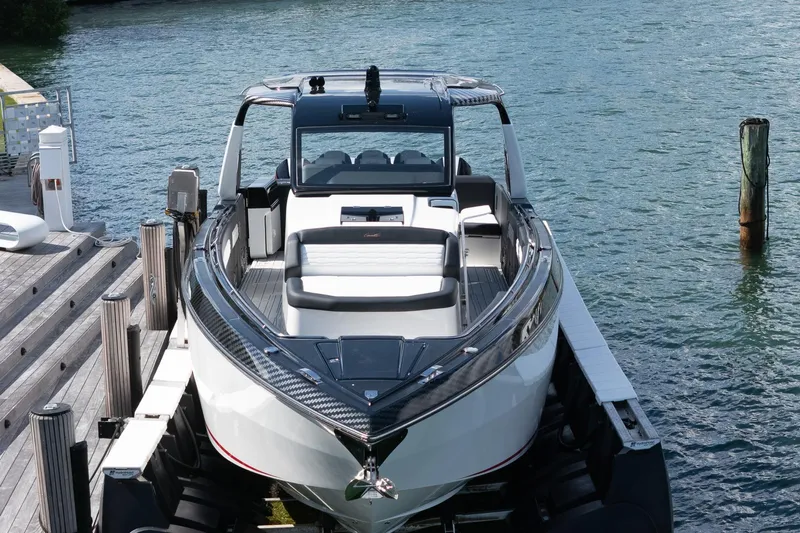  Yacht Photos Pics 2024 Cigarette 42 Auroris luxury boat docked on calm water.