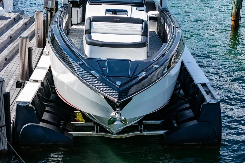  Yacht Photos Pics 2024 Cigarette 42 Auroris luxury boat docked on water, showcasing sleek design and modern features.