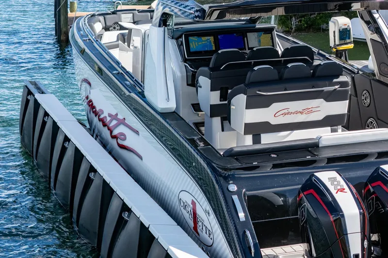  Yacht Photos Pics 2024 Cigarette 42 Auroris luxury speedboat with sleek design and powerful engines docked by the water.