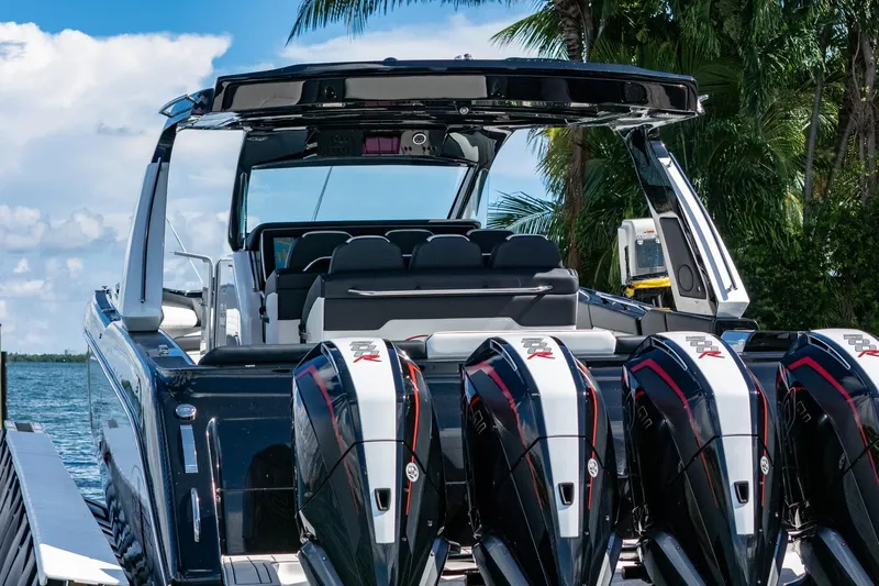  Yacht Photos Pics 2024 Cigarette 42 Auroris boat with powerful engines docked by palm trees.