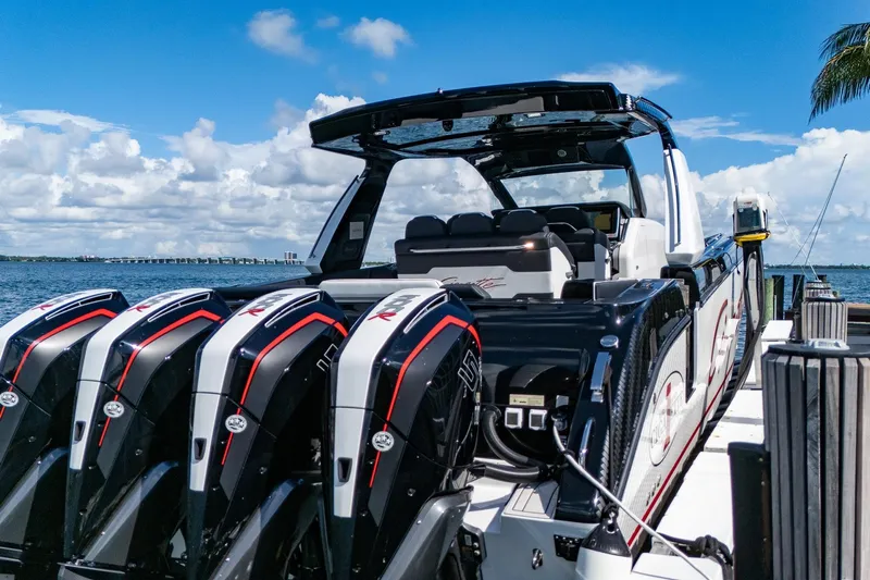  Yacht Photos Pics 2024 Cigarette 42 Auroris boat with multiple engines docked by the water.